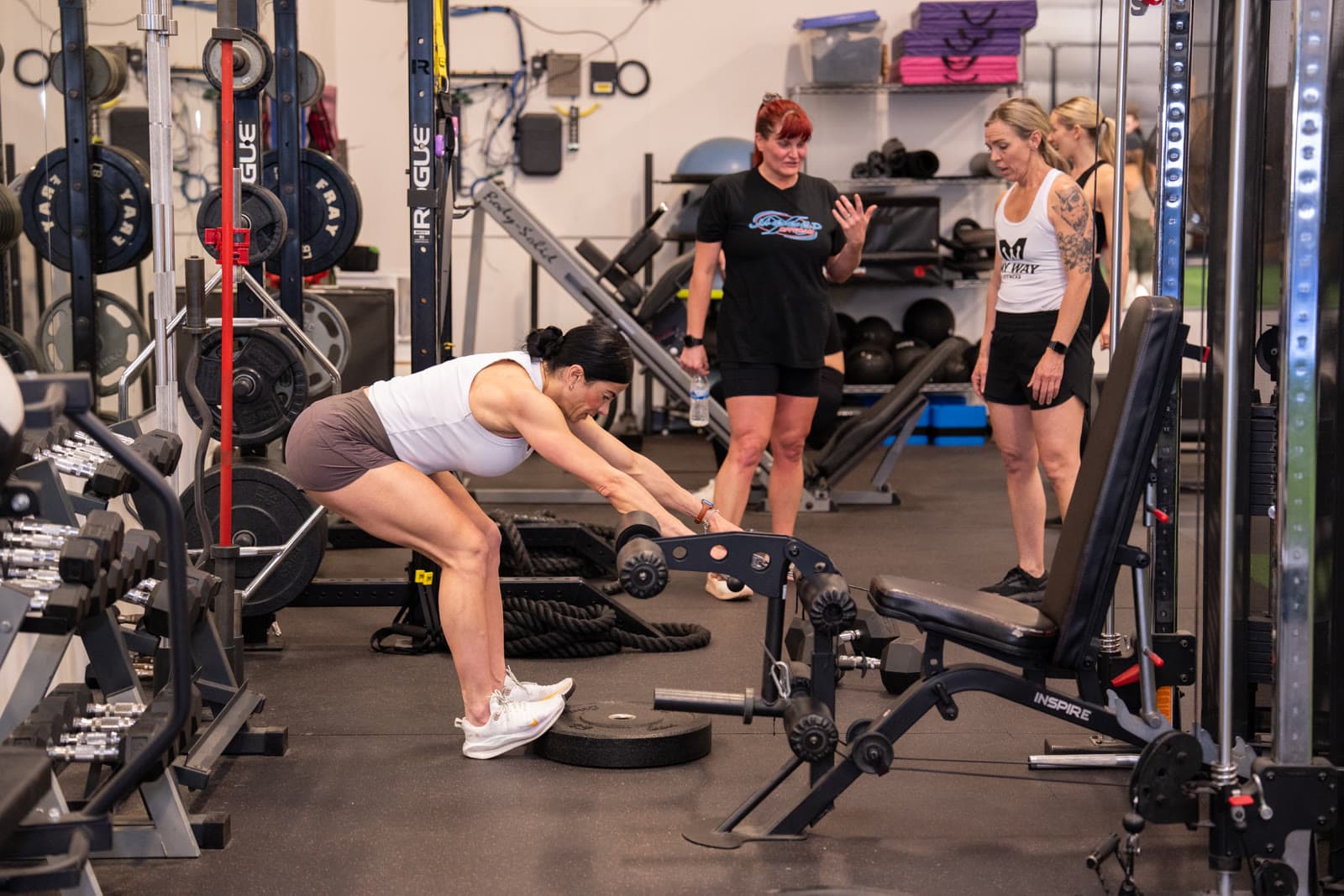 A coach setting up a member on the bench at the My Way Fitness studio
